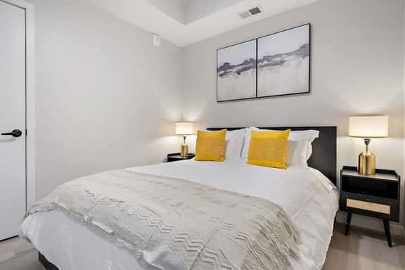 Bright and cozy bedroom with chic accents, plush bedding, and a tranquil vibe!