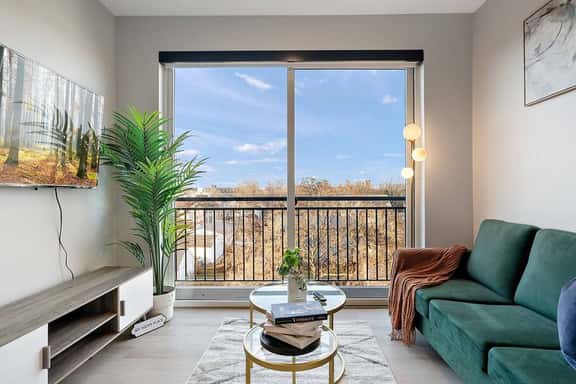 Modern oasis with stunning views, cozy velvet sofa, and chic decor. Relax & unwind!