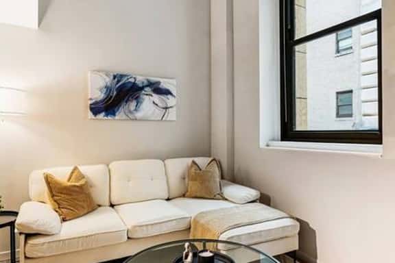 Modern loft with high ceilings, cozy seating, and chic decor in the heart of the city.