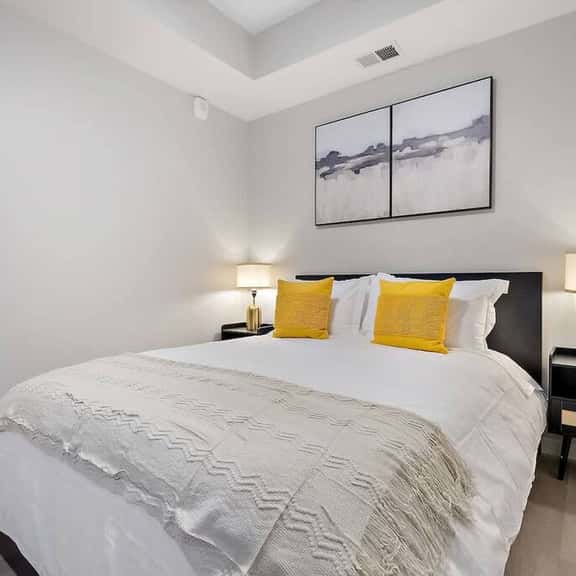 Bright and cozy bedroom with chic accents, plush bedding, and a tranquil vibe!