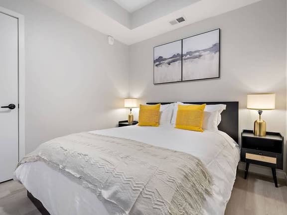 Bright and cozy bedroom with chic accents, plush bedding, and a tranquil vibe!