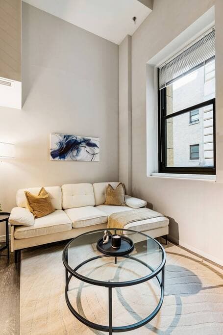 Modern loft with high ceilings, cozy seating, and chic decor in the heart of the city.